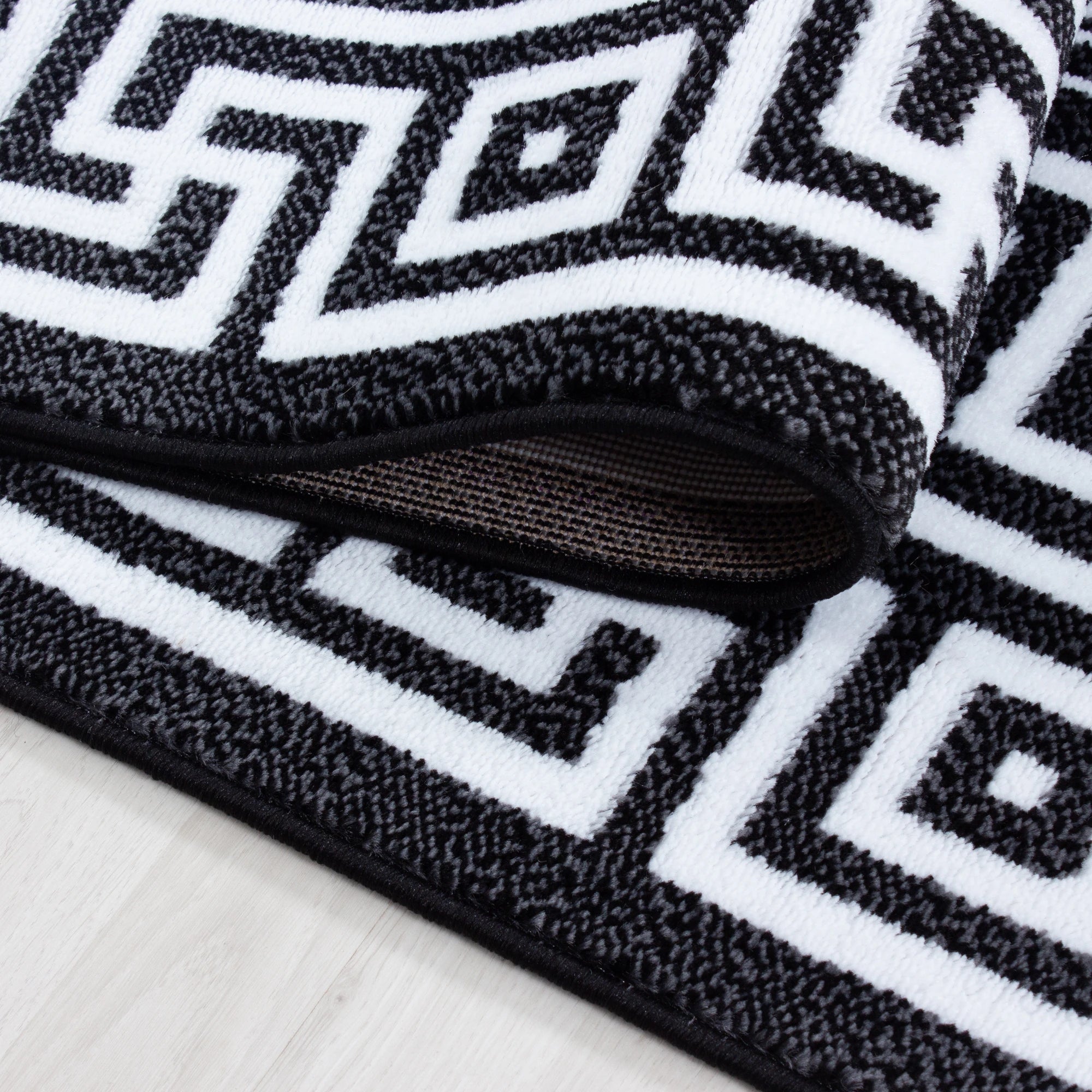 Teppich mit Mäandermuster in Schwarz