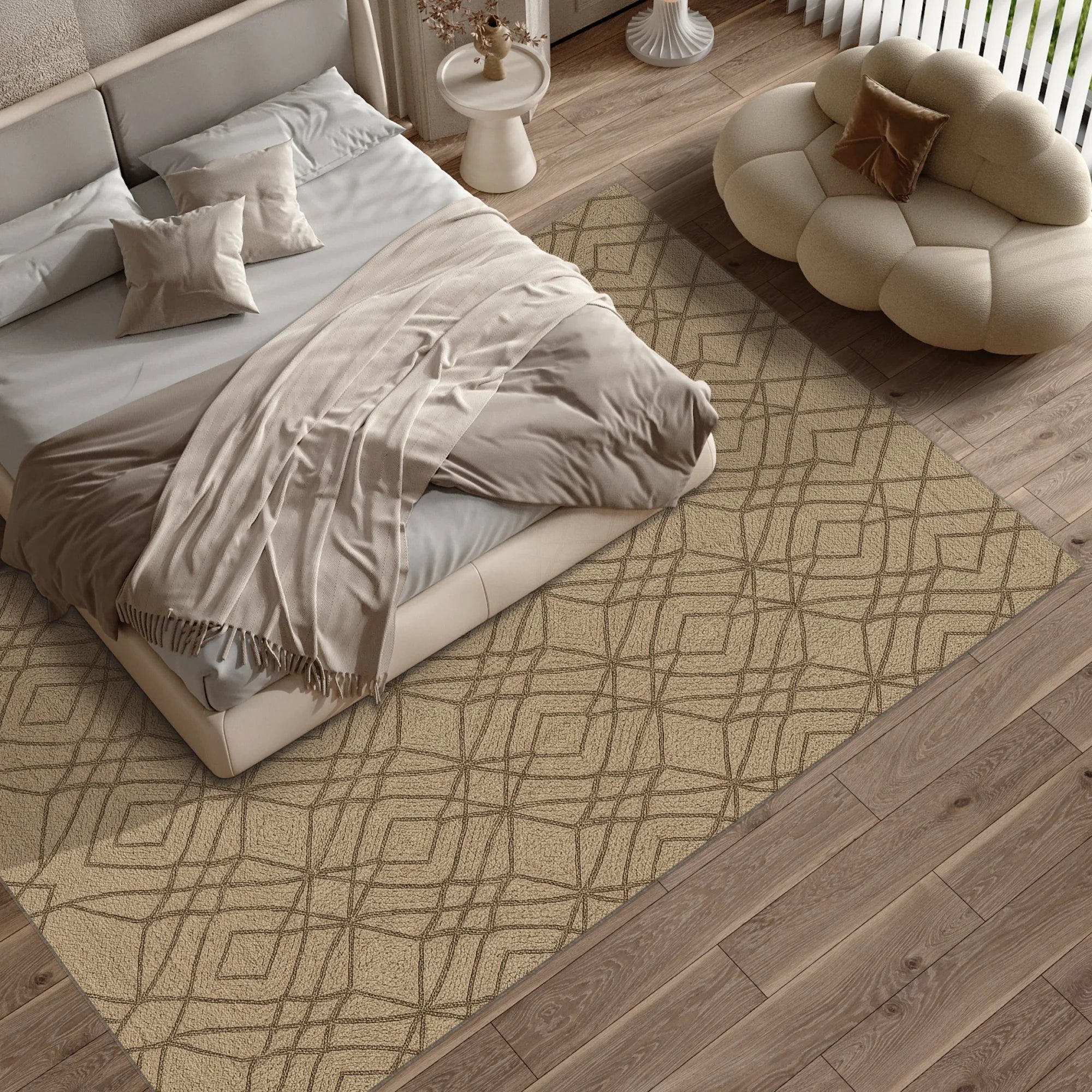 Neatly made bed with beige bedding on a geometric patterned rug in a bedroom.