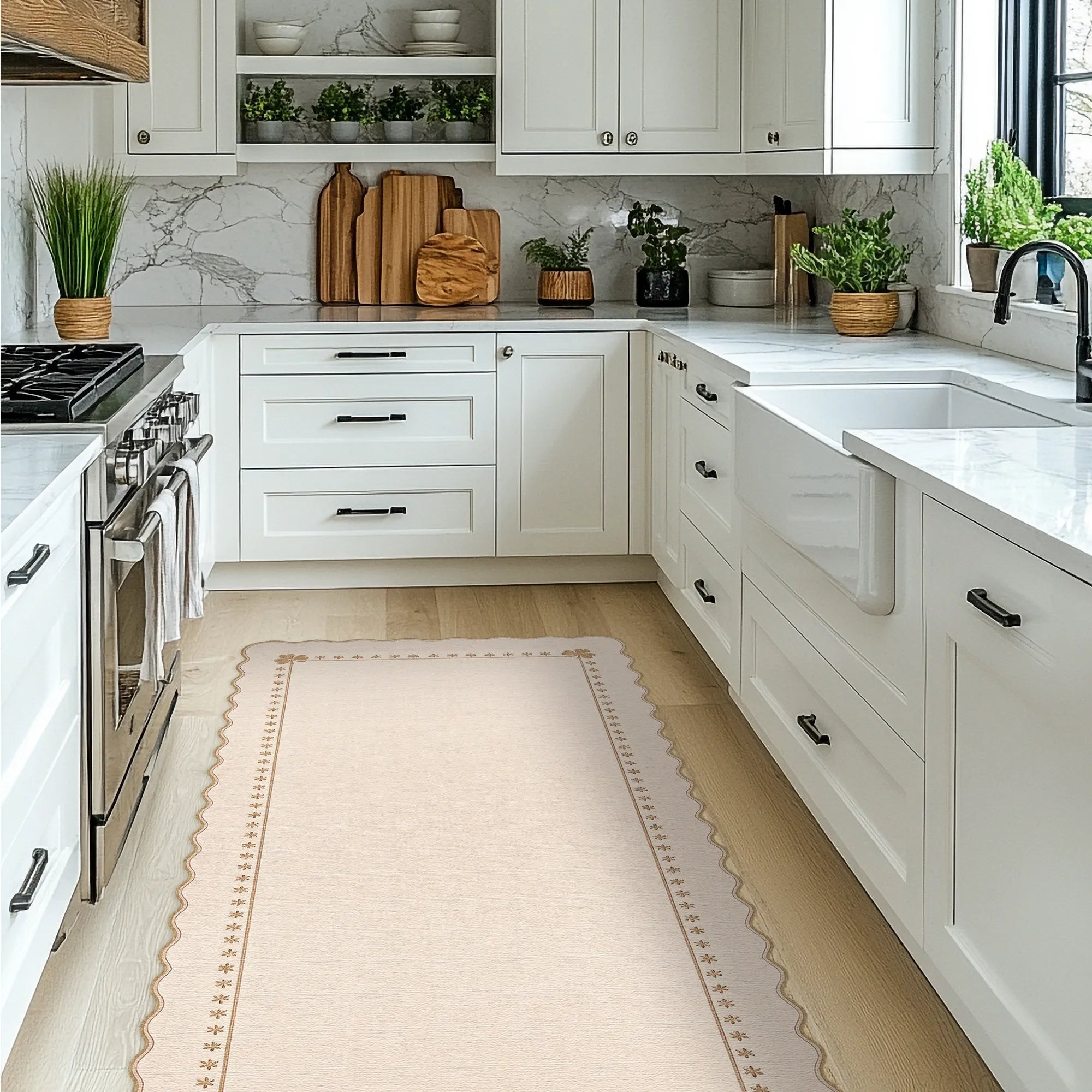 A light beige runner rug with a scalloped and patterned border is shown on a light wood floor in a bright, modern white kitchen.