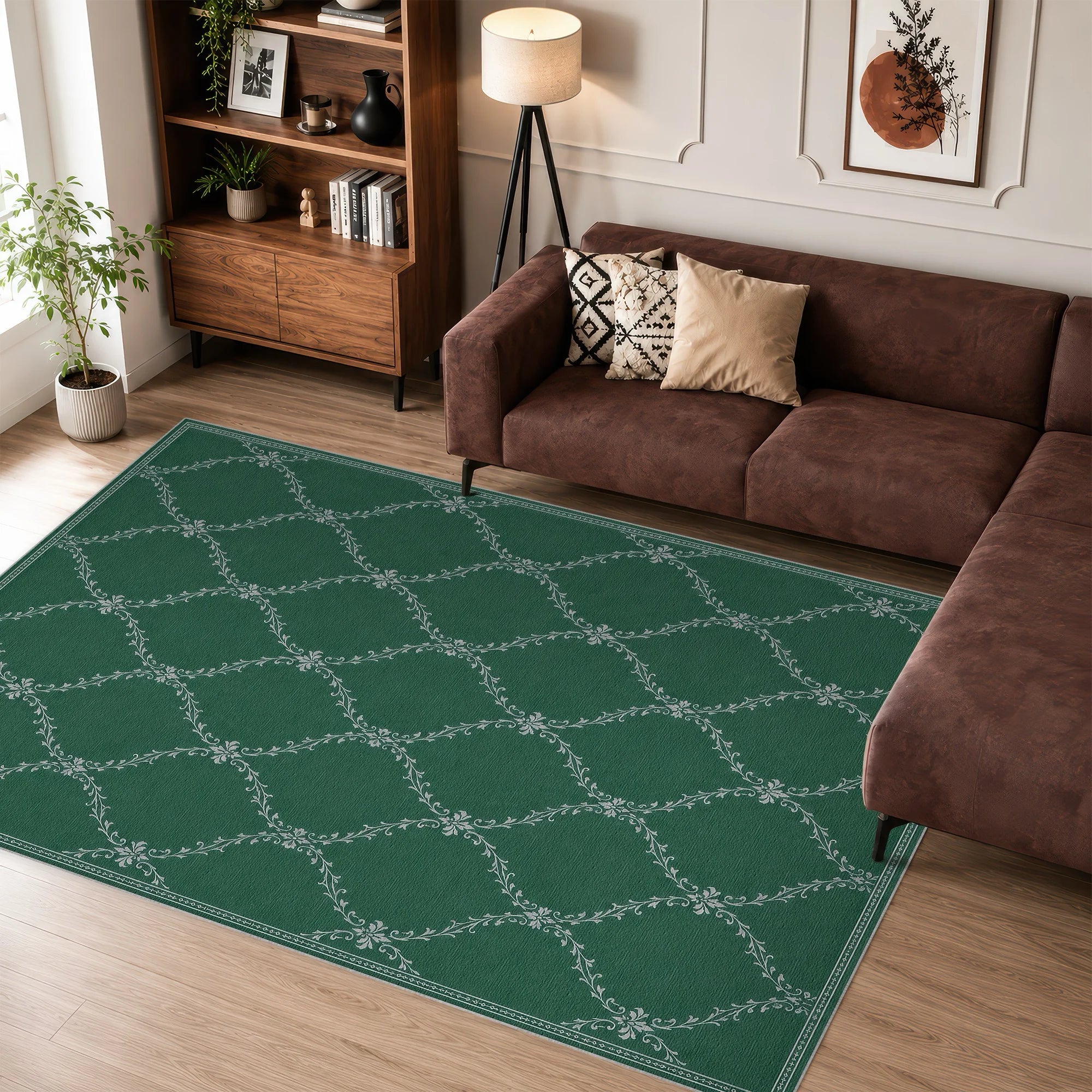 A green lattice area rug with a white geometric lattice pattern is shown in a styled living room setting next to a brown sectional sofa and wooden bookshelf.