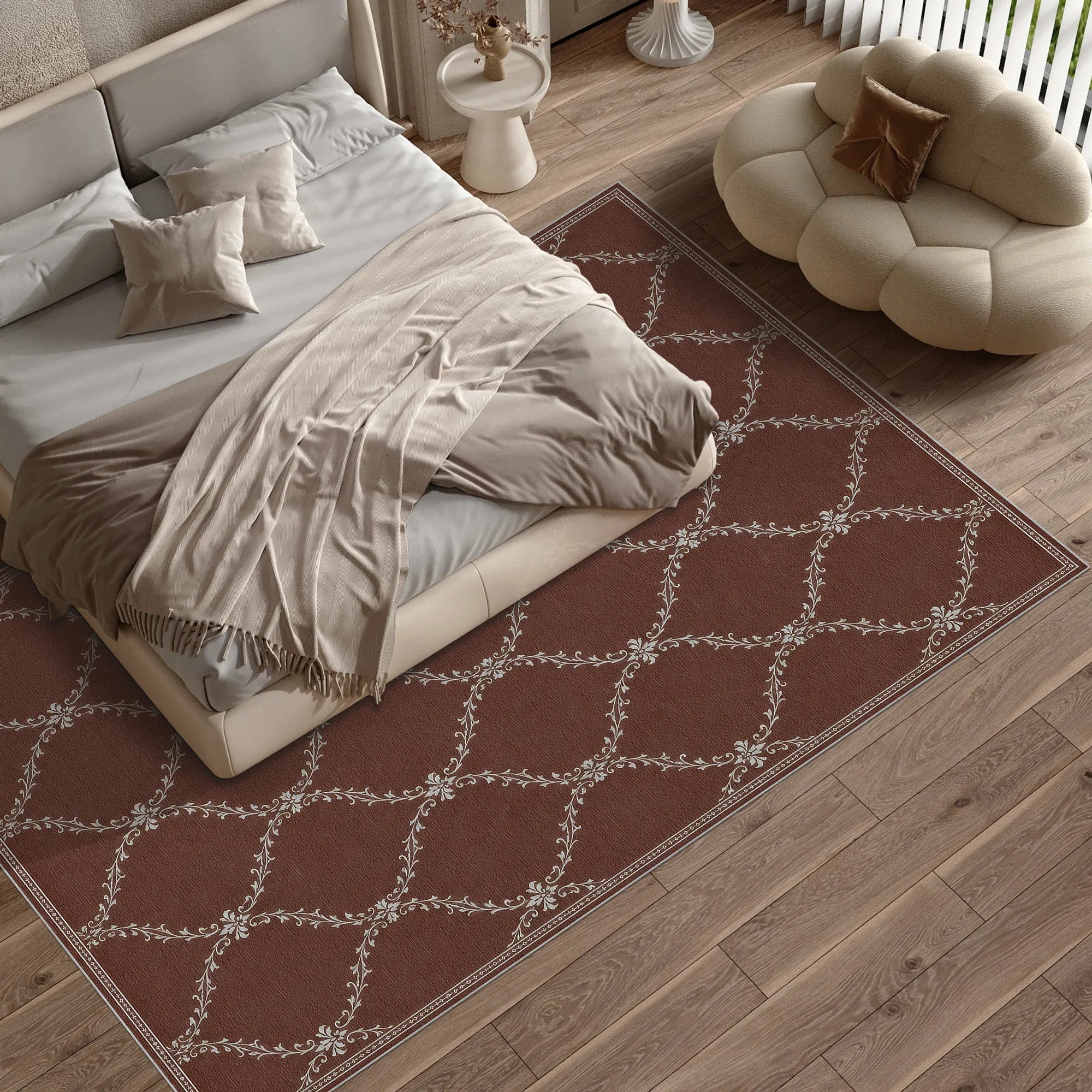 A rectangular lattice area rug with a brown background and a cream-colored geometric lattice pattern, styled on a light wood floor in a modern bedroom setting next to a bed and a cloud-shaped pouf.