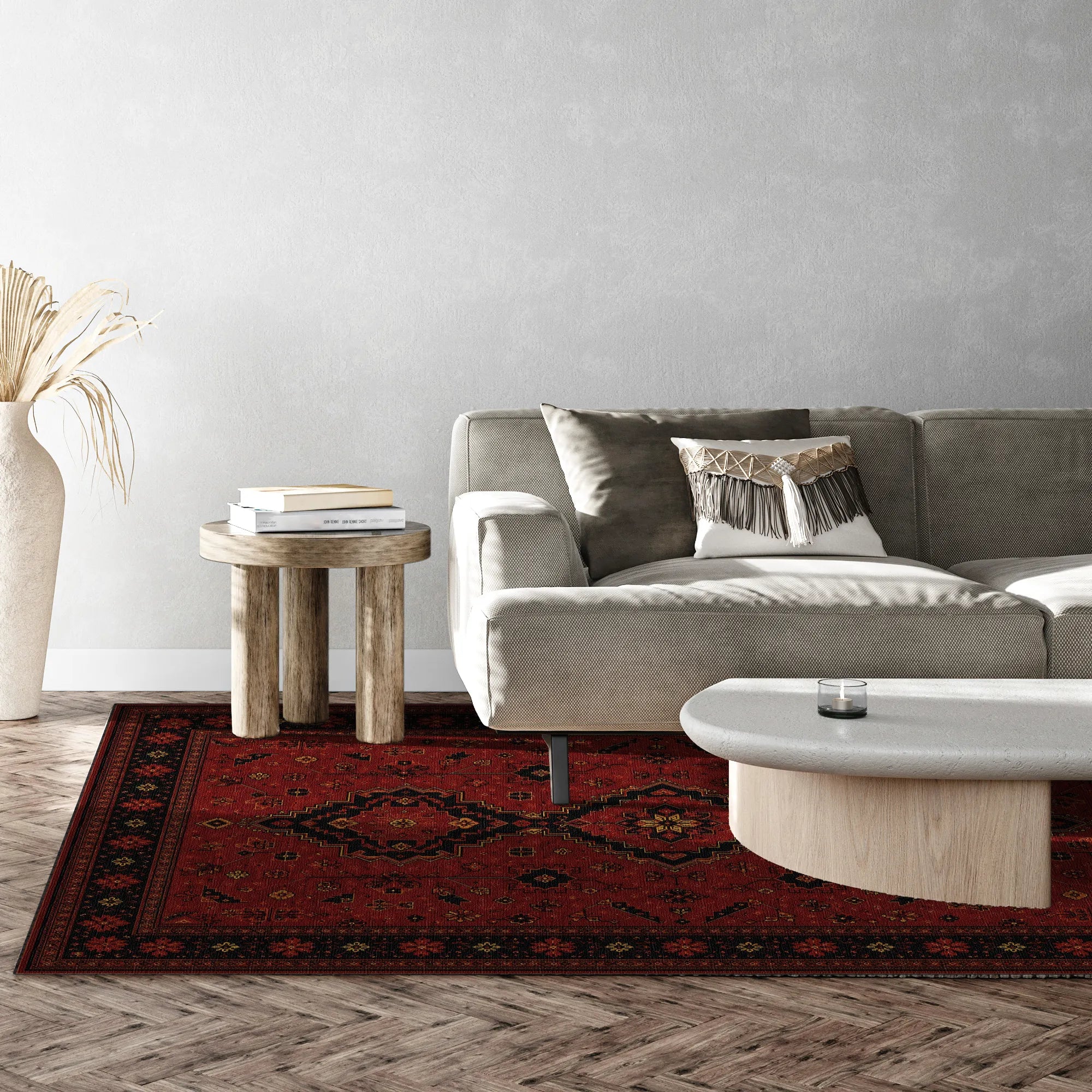 Ein rot-schwarz gemusteter Teppich in einem modernen Wohnzimmer mit einem grauen Sofa, einem hölzernen Beistelltisch und einem hellen Couchtisch.